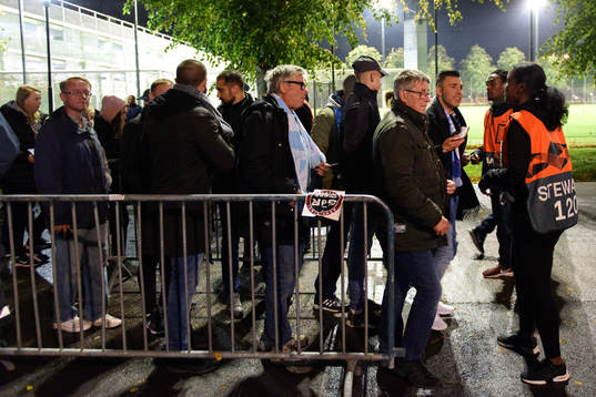Spectators enters the stadium