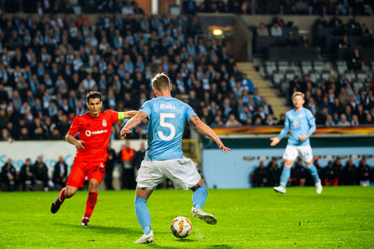 Sören Rieks of Malmö FF is guarded by Necip Uysal of