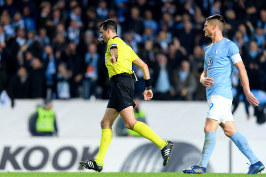 Referee Aleksandar Stavrev points at the penalty spot