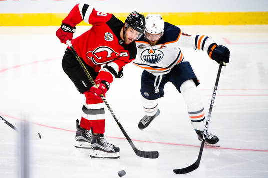 Taylor Hall of the New Jersey Devils and Adam Larsson of