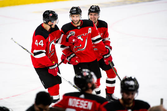 Miles Wood and John Quenneville of the New Jersey Devils