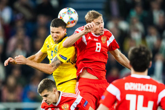 Marcus Berg of Sweden and Iury Gazinsky of Russia competes