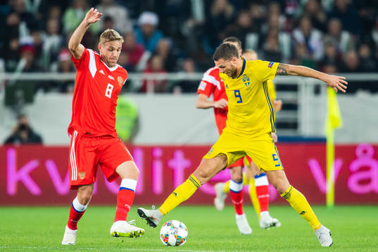 Marcus Berg of Sweden and Iury Gazinsky of Russia competes