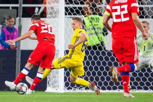 Ludwig Augustinsson of Sweden blocks a shot frpm Alexey