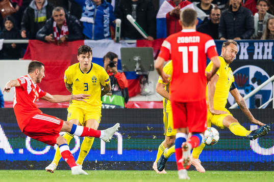 Andreas Granqvist of Sweden blocks a shot from Alexey Ionov