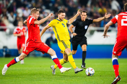Iury Gazinsky of Russia and Marcus Berg of Sweden competes