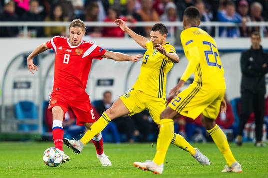 Iury Gazinsky of Russia and Marcus Berg of Sweden competes