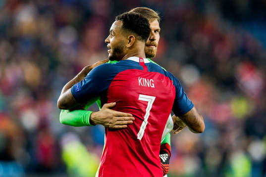 Joshua King of Norway and goalkeeper Vid Belec of Slovenia