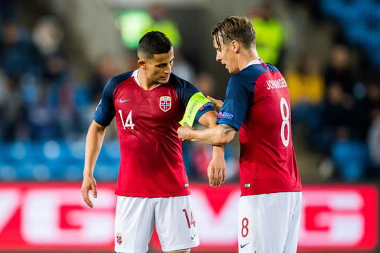 Stefan Johansen of Norway gives the captain's armband to