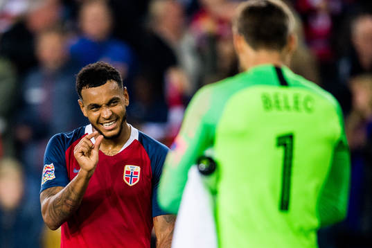 Joshua King of Norway and goalkeeper Vid Belec of Slovenia