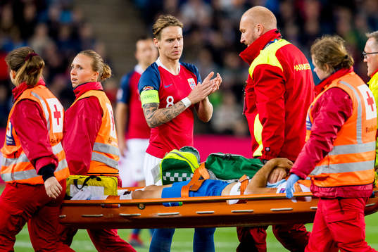 Stefan Johansen of Norway sees Luka Krajnc of Slovenia