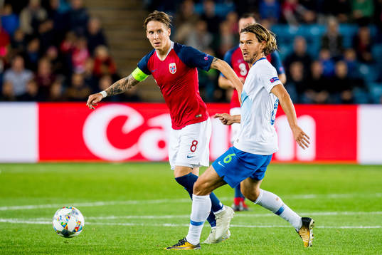 Stefan Johansen of Norway and René Krhin of Slovenia