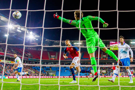 Bjørn Maars Johnsen of Norway and goalkeeper Vid Belec of