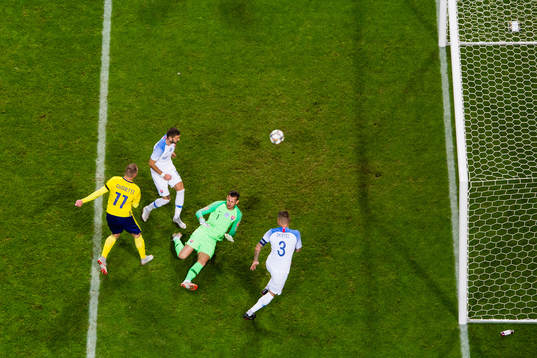 John Guidetti of Sweden scores 1-0 behind goalkeeper Martin