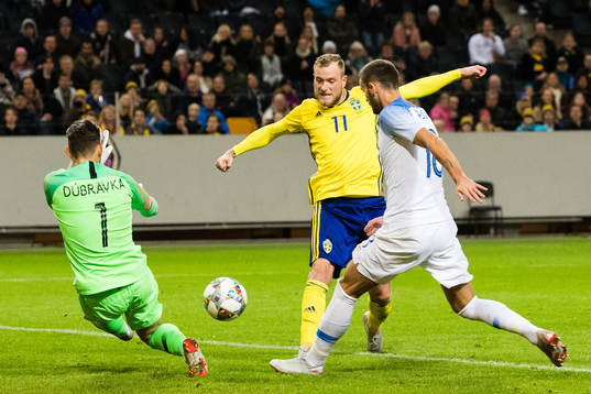 John Guidetti of Sweden scores 1-0 behind goalkeeper Martin