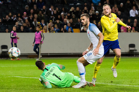 John Guidetti of Sweden scores 1-0 behind goalkeeper Martin