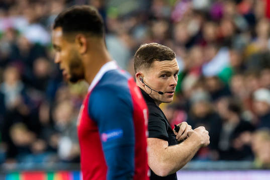Joshua King of Norway and referee John Beaton of Scotland