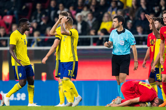 Referee Frank Schneider and Isak Ssewankambo of Sweden