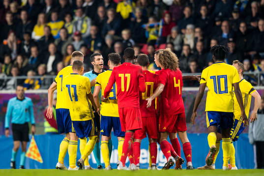 Referee Frank Schneider talks to the players
