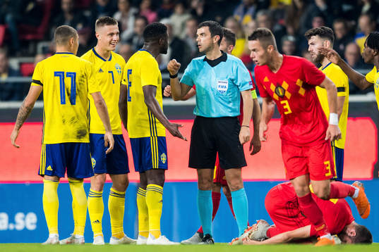 Referee Frank Schneider and Isak Ssewankambo of Sweden
