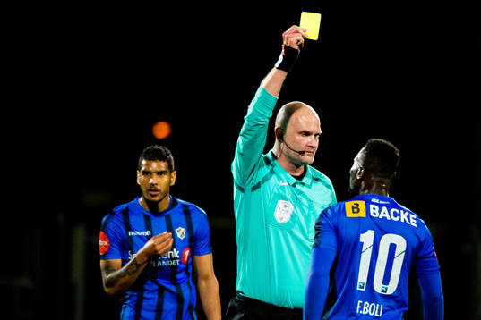 Franck Boli of Stabæk is shown a yellow card by referee
