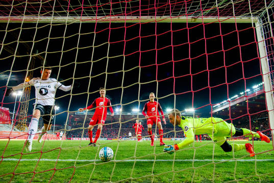 Pål André Helland of Rosenborg sees goalkeeper Markus