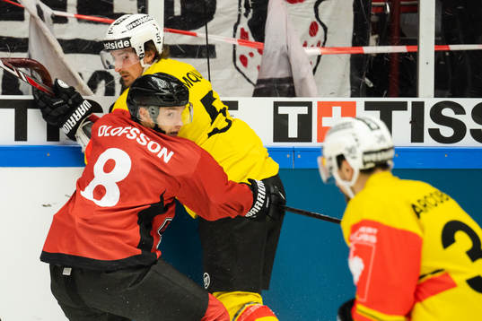Johan Olofsson of Malmö Redhawks tackles Adam Almquist of