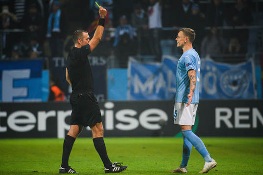 Markus Rosenberg of Malmö FF receives  a warning from