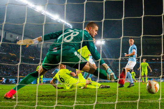 Marcus Antonsson of Malmö FF scores 1-1 behind Goalkeeper
