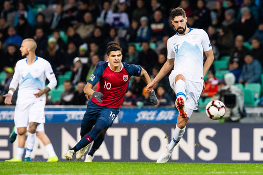 Tarik Elyounoussi of Norway and Miha Mevlja of Slovenia