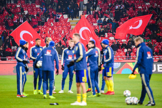 Turkish flags behind players of Sweden