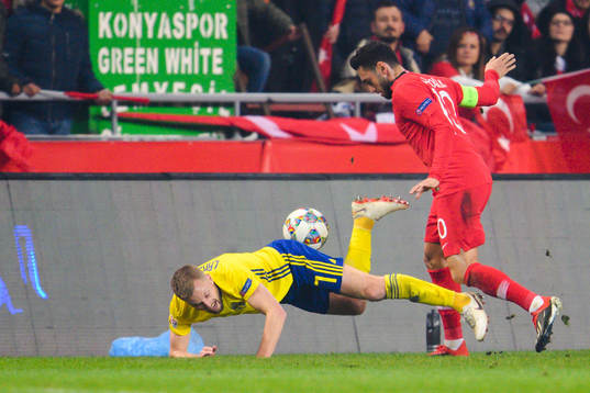 Sebastian Larsson of Sweden and Hakan Calhanoglu of Turkey
