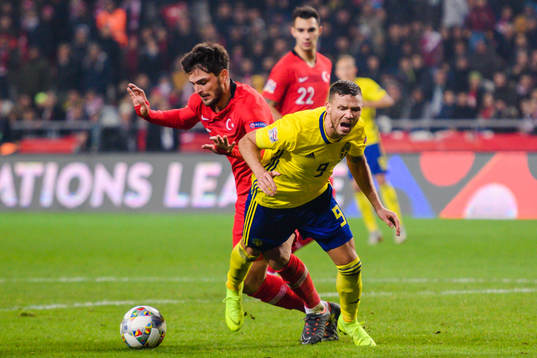 Okay Yokuslu of Turkey in duel with Marcus Berg of Sweden