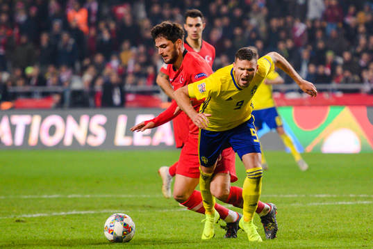 Okay Yokuslu of Turkey in a duel with Marcus Berg of Sweden