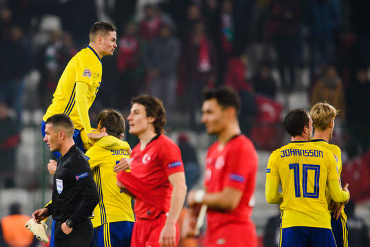 Mikael Lustig celebrates with Andreas Granqvist and Gustav
