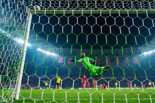 Goalkeeper Sinan Bolat of Turkey makes a save