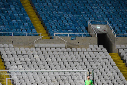 Empty seats behind Goalkeeper Rune Almenning Jarstein of