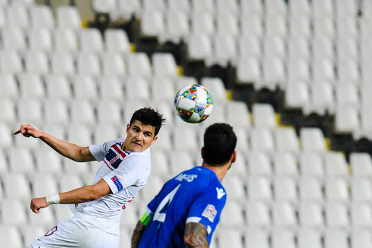 Tarik Elyounoussi of Norway and Giorgos Merkis of Cyprus
