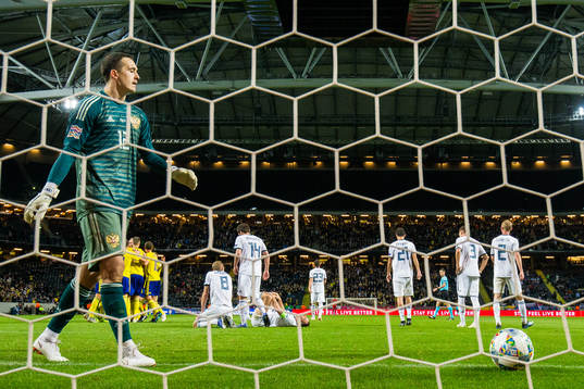 Goalkeeper Andrei Lunev of Russia looks dejected