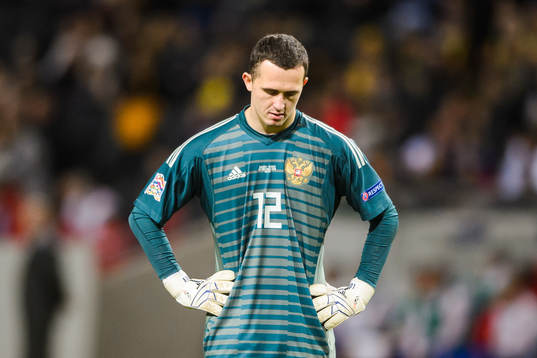 Goalkeeper Andrei Lunev of Russia looks dejected