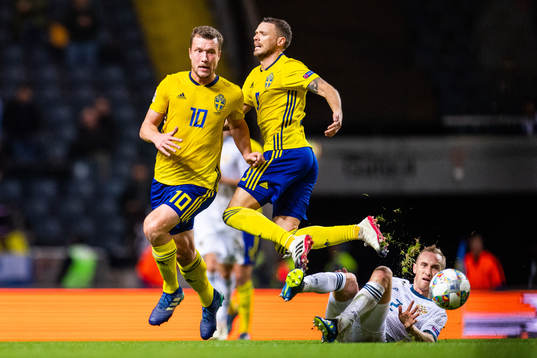 Jakob Johansson and Marcus Berg of Sweden in a duel with