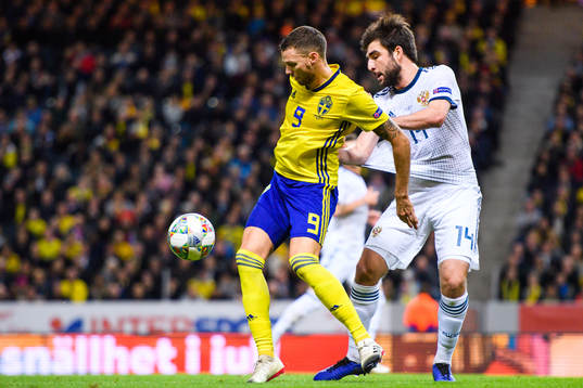 Marcus Berg of Sweden and Giorgi Dzhikiya of Russia