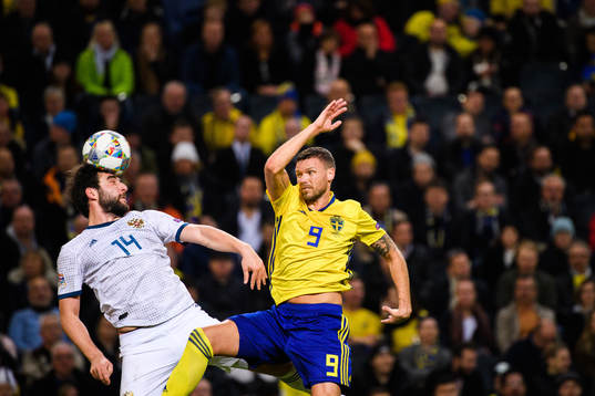 Giorgi Dzhikiya of Russia and Marcus Berg of Sweden