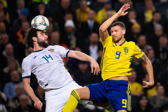 Giorgi Dzhikiya of Russia and Marcus Berg of Sweden