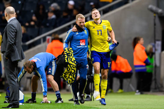 Viktor Claesson of Sweden leaves the pitch with a injury