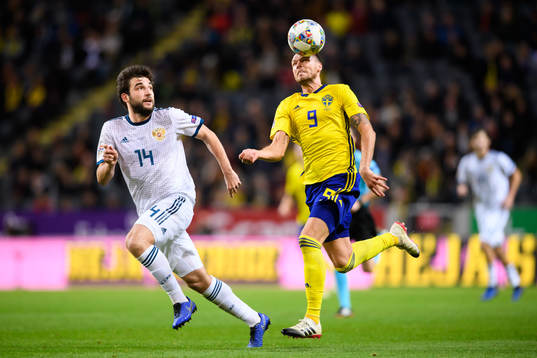 Giorgi Dzhikiya of Russia and Marcus Berg of Sweden