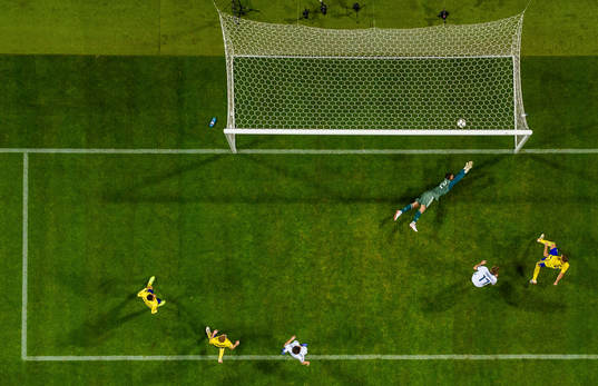 Marcus Berg of Sweden scores the 2-0 goal behind goalkeeper