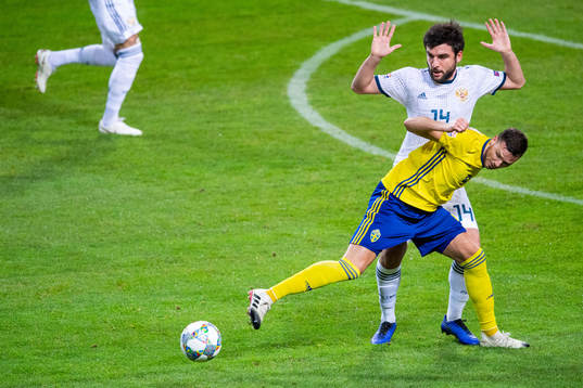 Marcus Berg of Sweden and Giorgi Dzhikiya of Russia