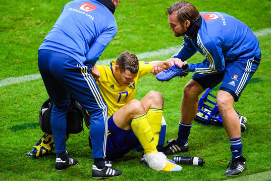Viktor Claesson of Sweden receives help