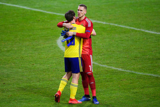 Gustav Svensson and goalkeeper Robin Olsen of Sweden